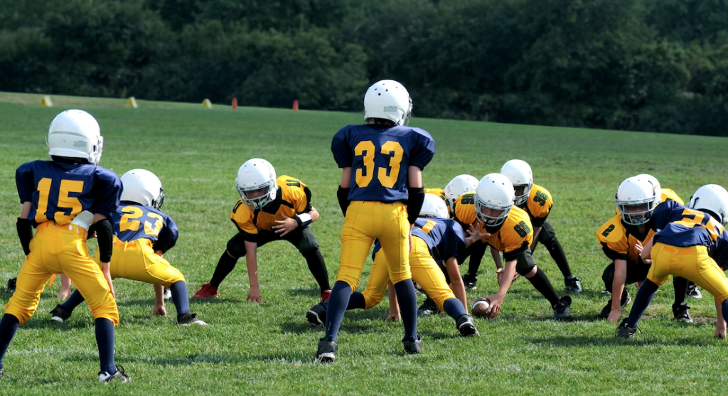 Stretching youth football players before practice happens for one of two reasons. Both are wrong for your Pop Warner & NFL Flag aged players.